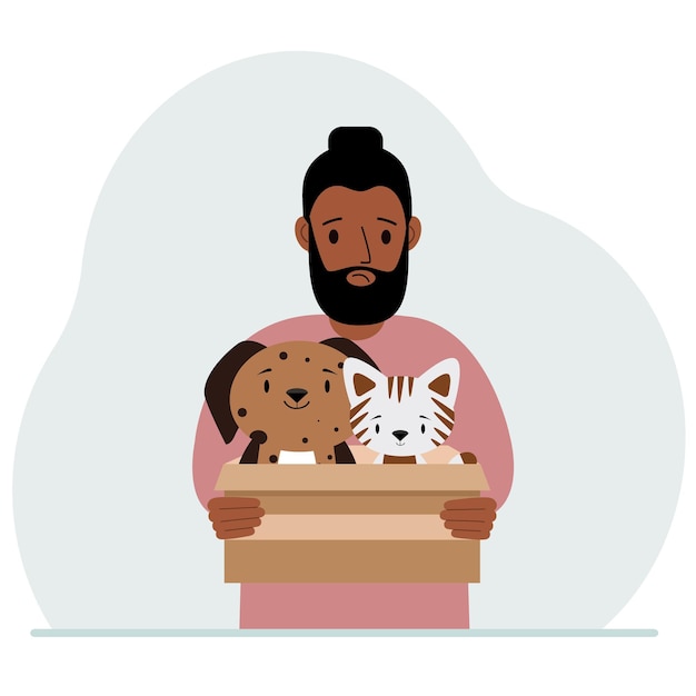 A man holds a cardboard box with a cat and a dog The concept of rescue help and care for pets