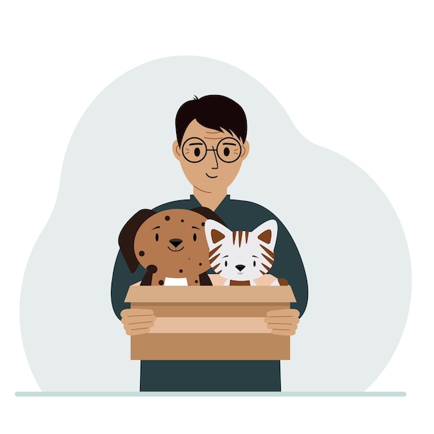 A man holds a cardboard box with a cat and a dog The concept of rescue help and care for pets