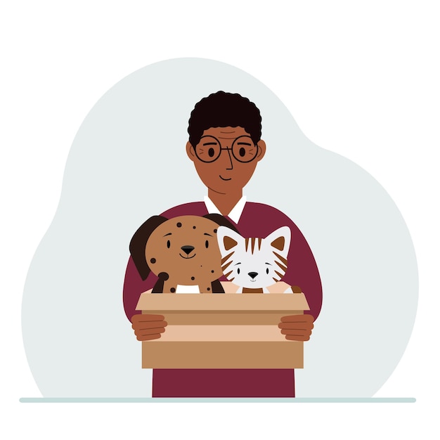 A man holds a cardboard box with a cat and a dog The concept of rescue help and care for pets