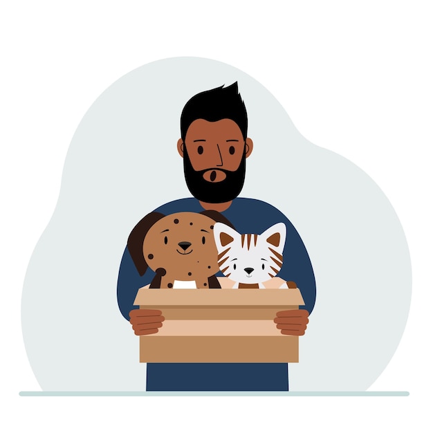 A man holds a cardboard box with a cat and a dog The concept of rescue help and care for pets