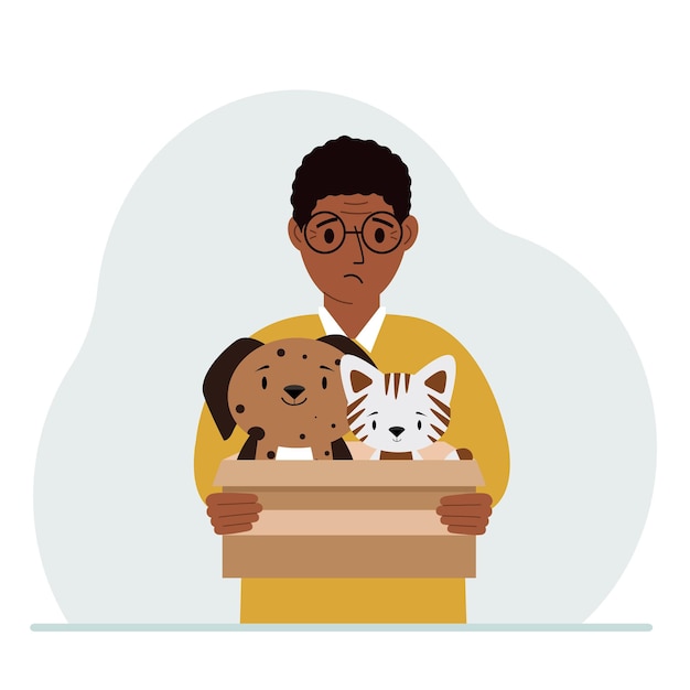 A man holds a cardboard box with a cat and a dog The concept of rescue help and care for pets