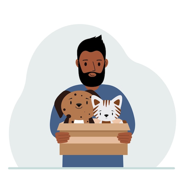 A man holds a cardboard box with a cat and a dog The concept of rescue help and care for pets