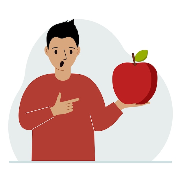 A man holds a fresh and red apple in his hand Man eats an apple Healthy food concept