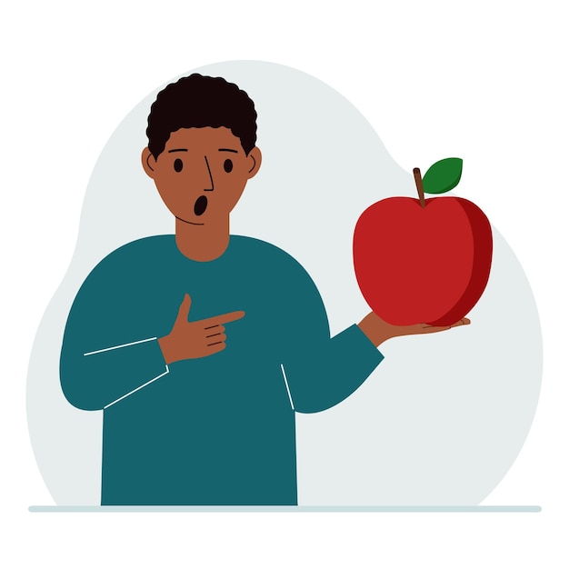 A man holds a fresh and red apple in his hand Man eats an apple Healthy food concept