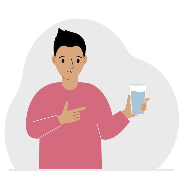 A man holds a glass of water in his hand The concept of water balance and health