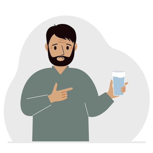 A man holds a glass of water in his hand The concept of water balance and health