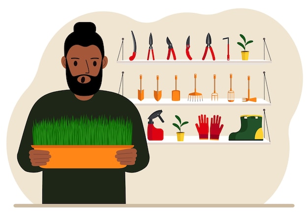 A man holds a plant in his hands against the background of gardening tools Gardening concept