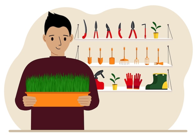 A man holds a plant in his hands against the background of gardening tools Gardening concept