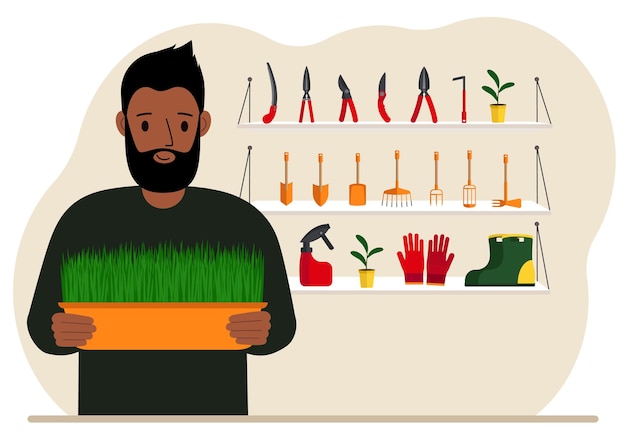 A man holds a plant in his hands against the background of gardening tools Gardening concept