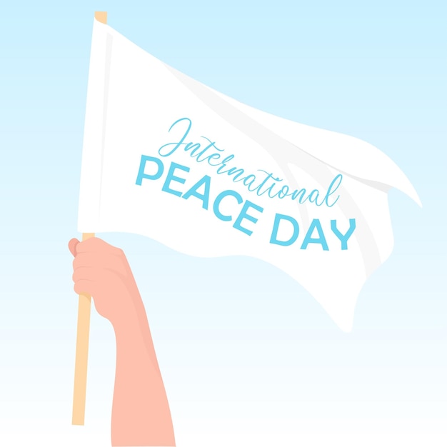 A man's hand holds a white flag in honor of the international day of peace