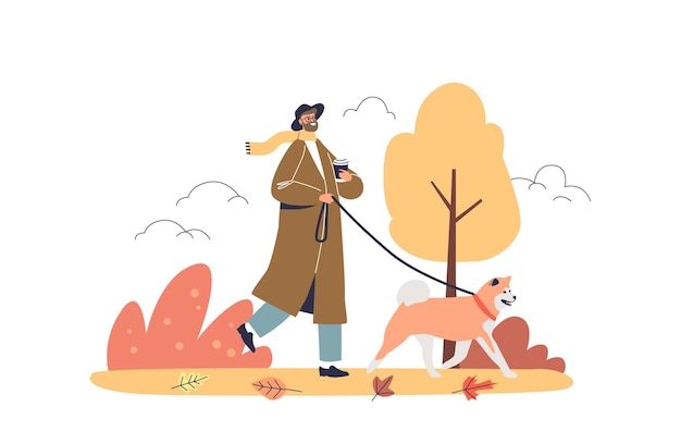 Man walking dog in autumn park Young hipster guy in trendy trench drink coffee to go in fall forest