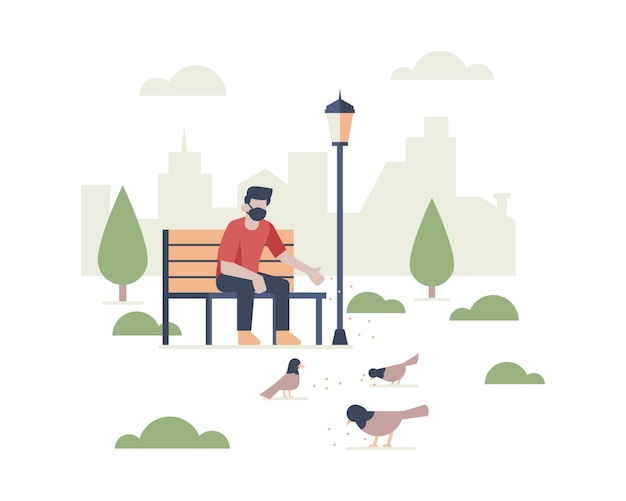 A man wearing a face mask sitting in public park while feeding birds with city building landscape silhouette illustration