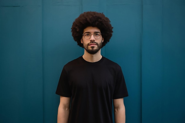 a man with an afro stands in front of a blue wall man with curly hair posing fashion modern style