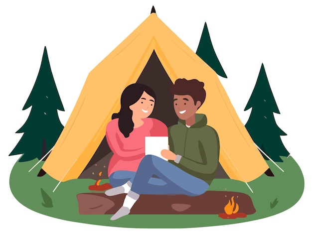 A man and woman sitting in front of a tent with a tablet in front of them.