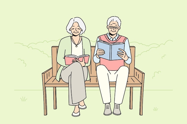 Mature couple on bench reading books