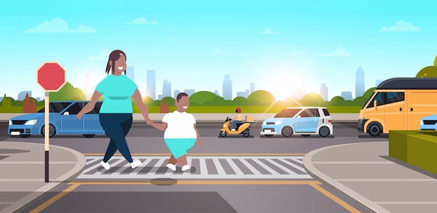 mother with son walking city urban street   family crossing road on crosswalk concept character full length landscape background horizontal