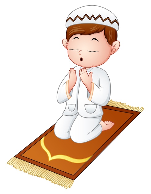 Muslim kid sitting on the prayer rug while praying