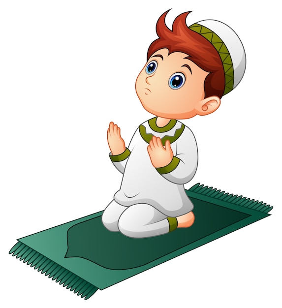 Muslim kid sitting on the prayer rug while praying