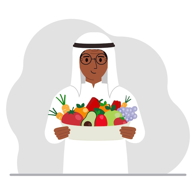 A muslim man with a large plate of healthy organic food vegetables and fruits The concept of healthy food healthy lifestyle vegetarianism agriculture