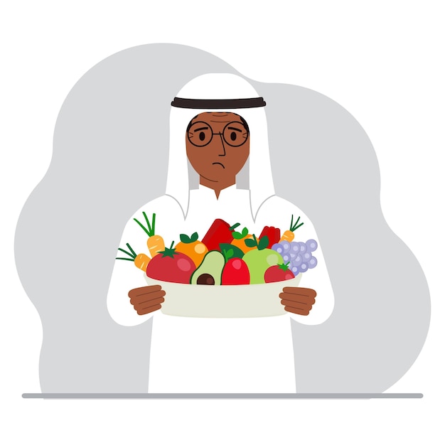 A muslim man with a large plate of healthy organic food vegetables and fruits The concept of healthy food healthy lifestyle vegetarianism agriculture