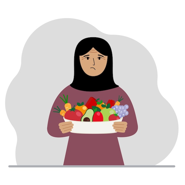 A muslim woman with a large plate of healthy organic food vegetables and fruits The concept of healthy food healthy lifestyle vegetarianism agriculture