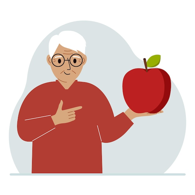 A old man holds a fresh and red apple in his hand Man eats an apple Healthy food concept