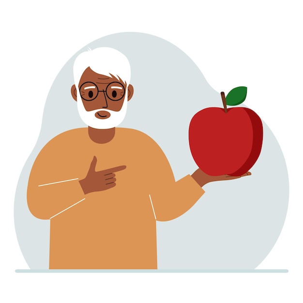 A old man holds a fresh and red apple in his hand Man eats an apple Healthy food concept