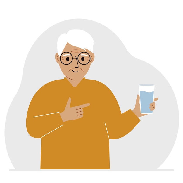 A old man holds a glass of water in his hand The concept of water balance and health