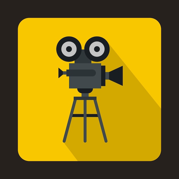 Old movie camera with reel icon in flat style on a yellow background