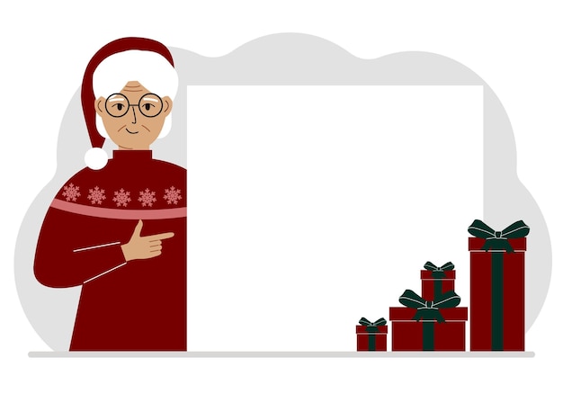 A old woman in a Christmas or New Year's sweater with a red sana cap points his finger at a banner a blank poster or a large white sheet of paper with space for text