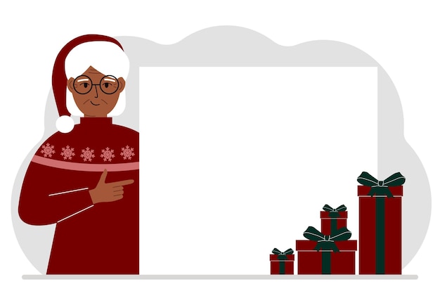 A old woman in a Christmas or New Year's sweater with a red sana cap points his finger at a banner a blank poster or a large white sheet of paper with space for text