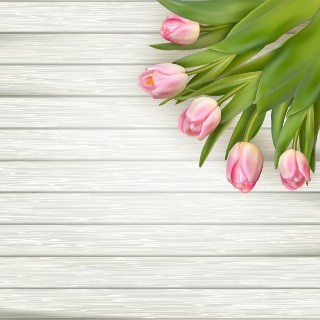 Pink tulips over white wood table.