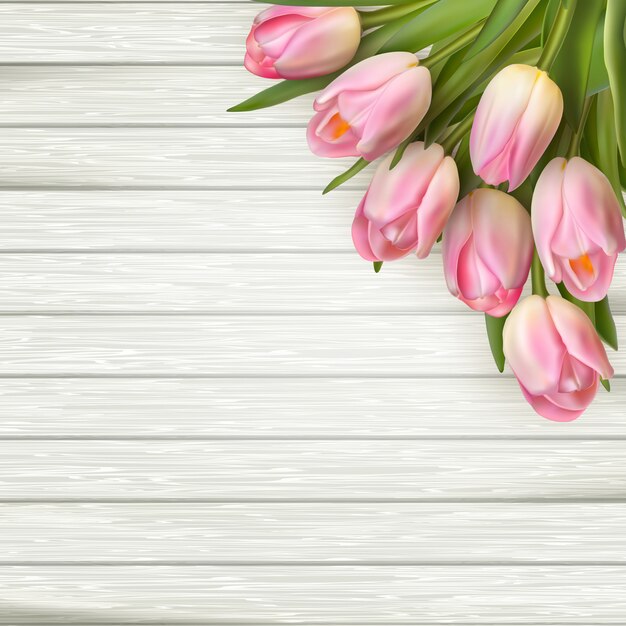 Pink tulips on wooden background.