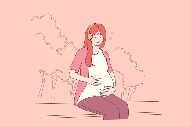 Pregnancy, mother and baby concept. Young smiling asian pregnant mother sitting on bench and listening to music hugging belly expecting for baby