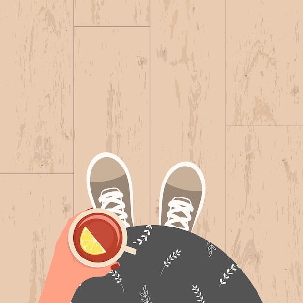 Pregnant girl in sneakers holding a cup of tea with a slice of lemon top view of her tummy Vectorx9