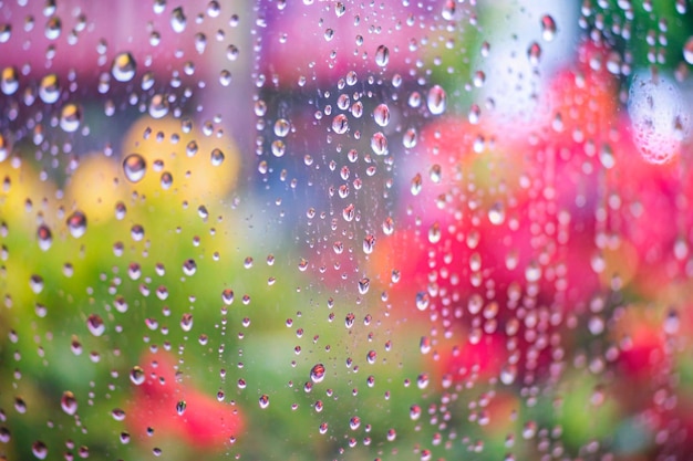 a raindrops on a window with a blurred background