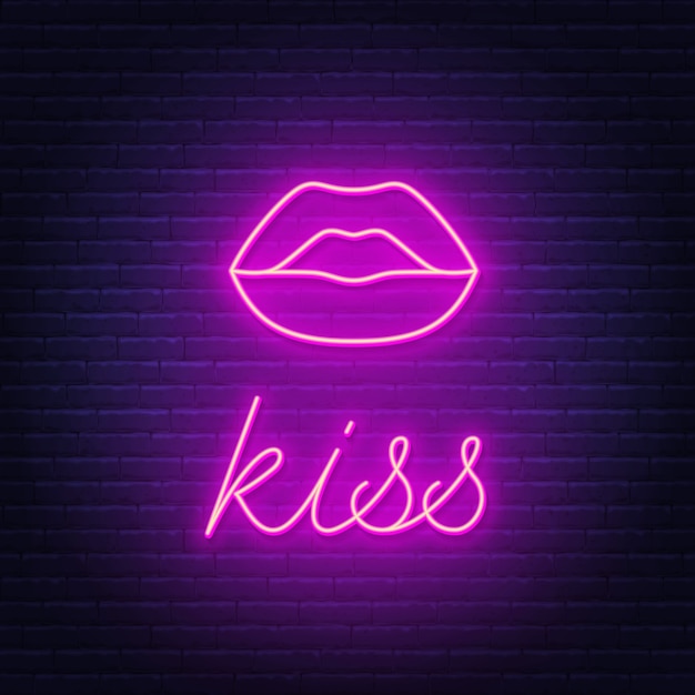 Red lips neon sign on brick wall background.