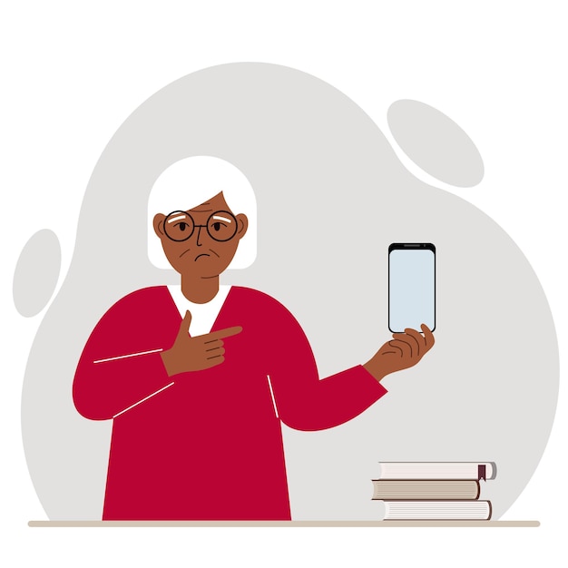 A sad grandmother holds a mobile phone in one hand and points at it with the index finger of his other hand.