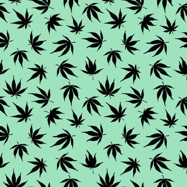 Seamless pattern of black cannabis leaves on a green background