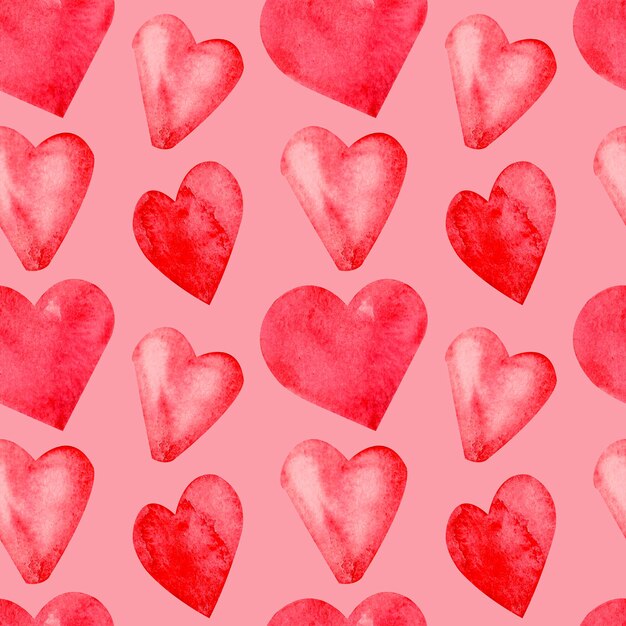 Seamless pattern with hand painted watercolor red hearts on pink background