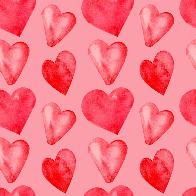 Seamless pattern with hand painted watercolor red hearts on pink background