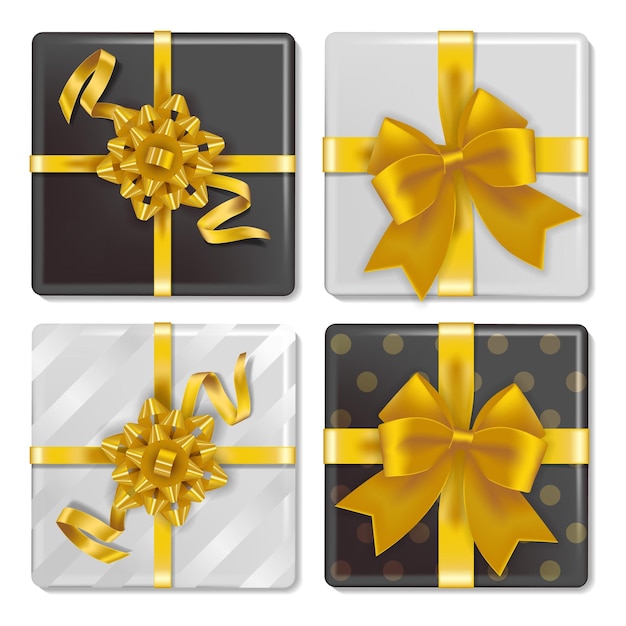 Set of gift boxes tied with golden ribbons, with white and black wrapping