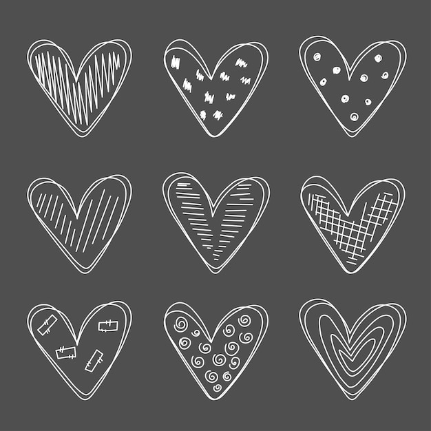 Set of scribble hearts drawn with chalk on a black board Hearts collection with decoration