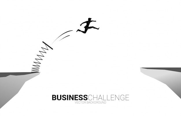 Silhouette of businessman jump over the gap with springboard. Concept of boost and growth in business.