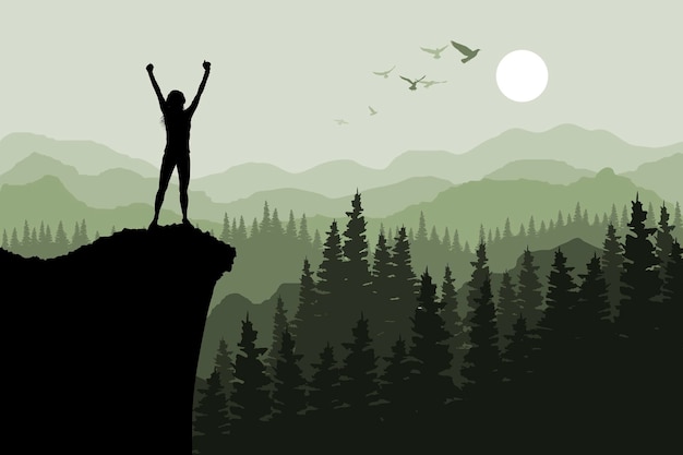 Silhouette of a person with raised hands on a cliff with mountains in the background