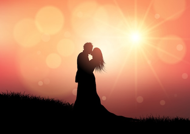 Silhouette of a wedding couple on sunset background