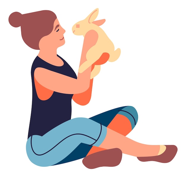 Sitting woman holding rabbit. Girl playing with bunny. Cute lovely pet