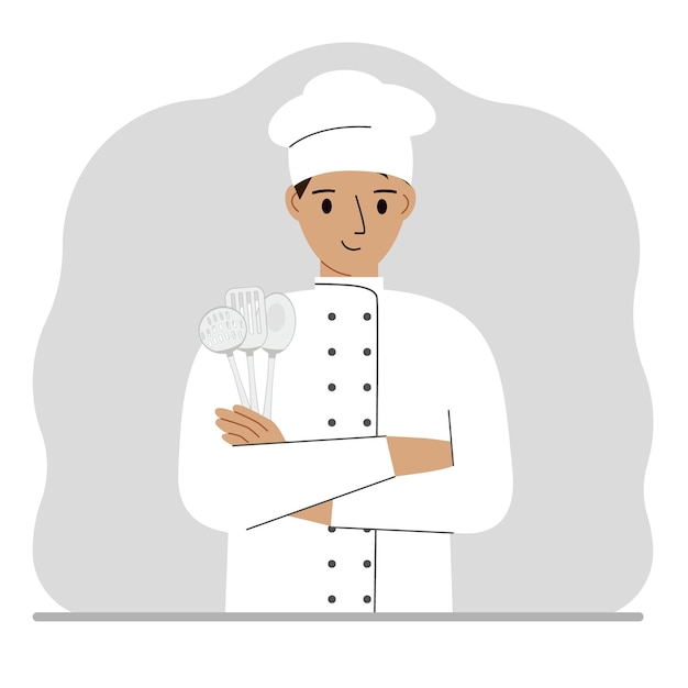 Smiling chef holds a kitchen cutlery set in his hand profession