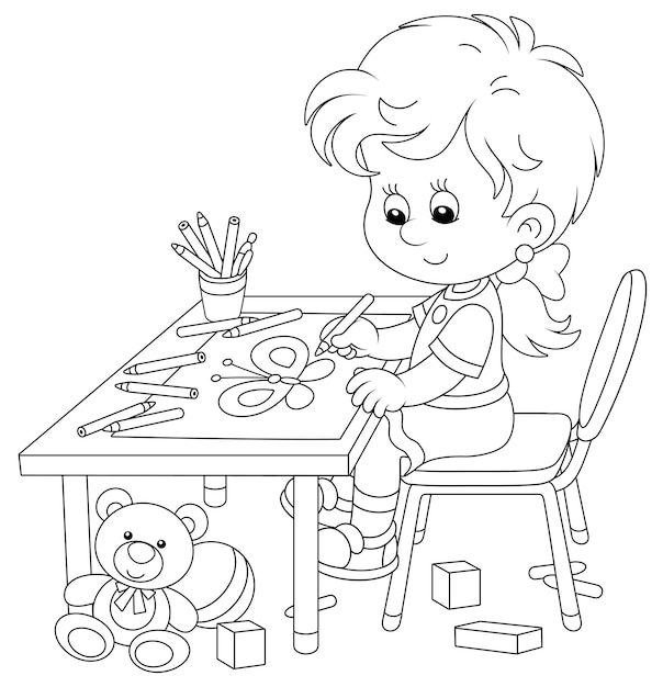 Smiling little girl sitting at her table and drawing with pencils a funny picture of a butterfly