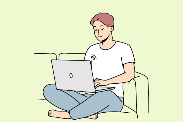 Smiling man on couch using laptop